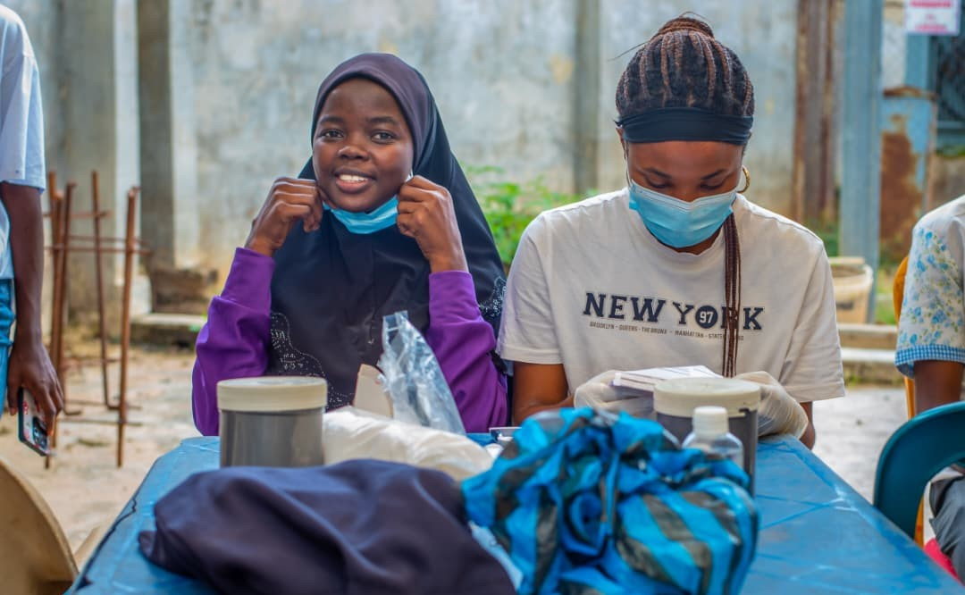 Medical outreach: two students at a table in the community.